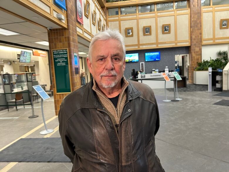 A man in a brown leather jacket.