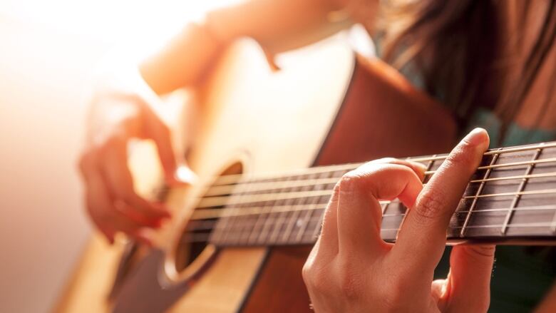 A woman playing guitar