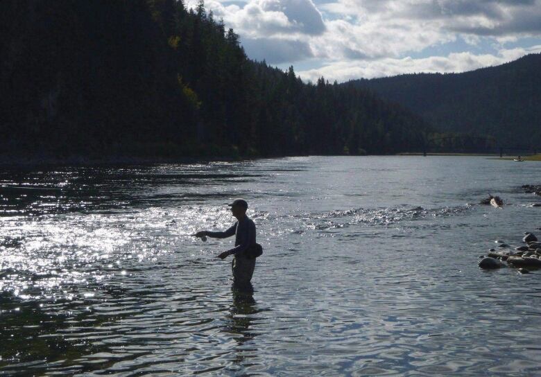 A fisherman in a river.