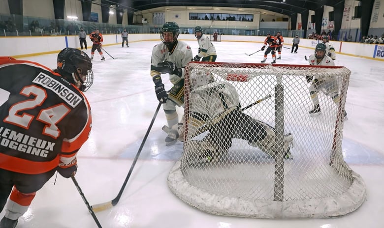 hockey action behind the next in a small arena 