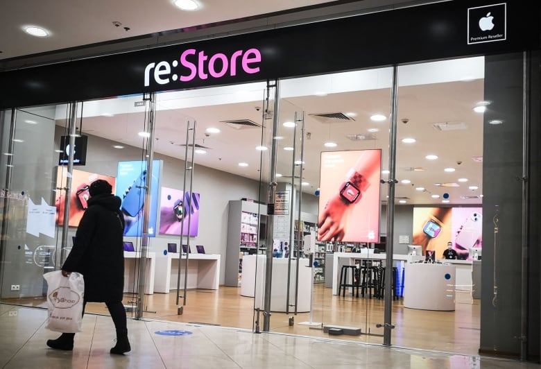 A customer walks past a store that sells Apple products in Moscow on March 7, 2022. 