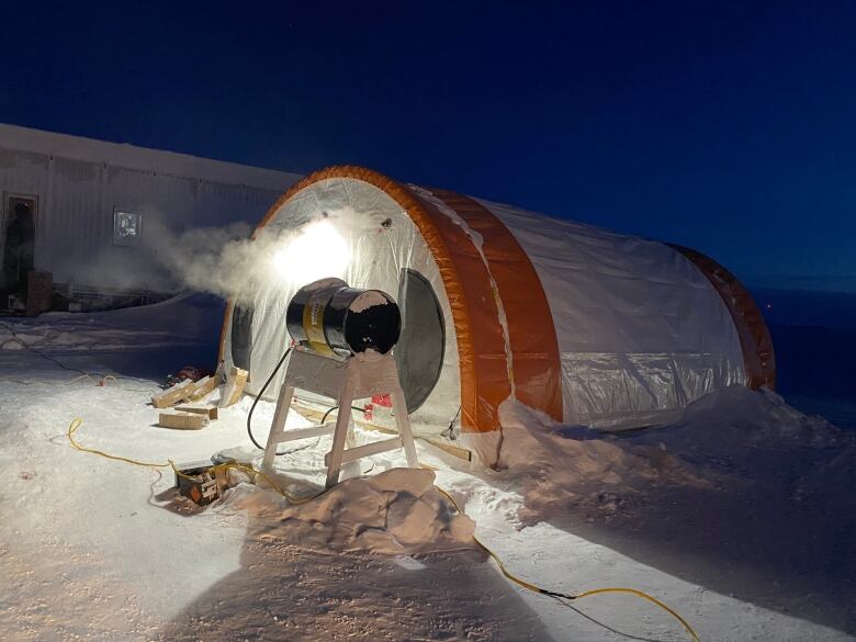 An inflatable military tent in a winter landscape.