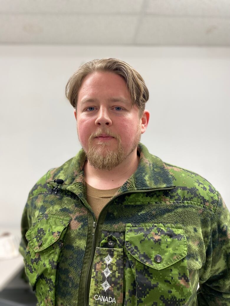 A man in a military uniform stares straight.