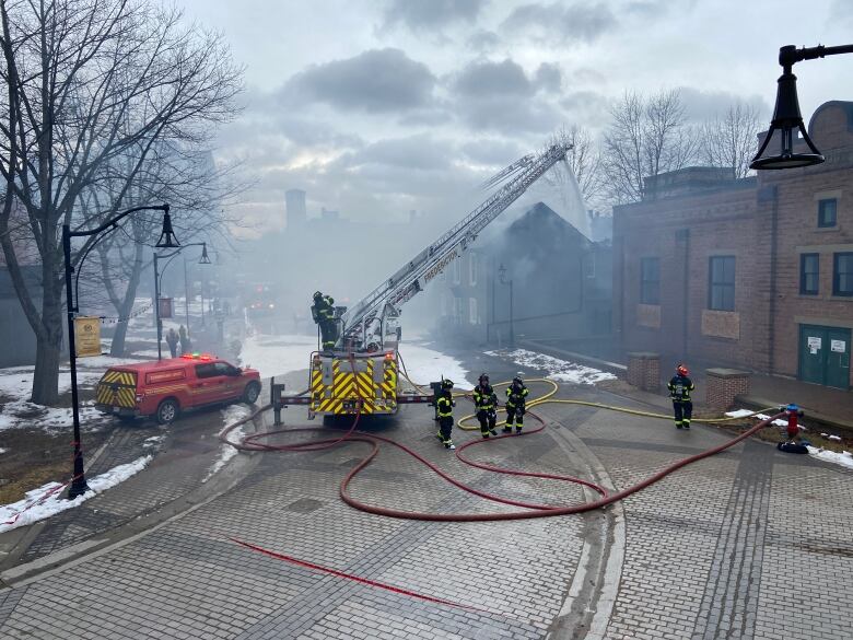 Firefighters battle a fire on Carleton Street in Fredericton.