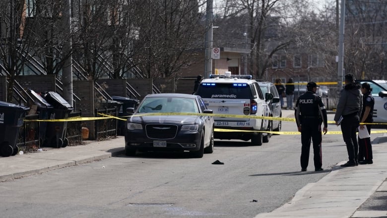 Police work the scene of a fatal shooting in downtown Toronto on Tuesday, March 12, 2024.  THE CANADIAN PRESS/Arlyn McAdorey