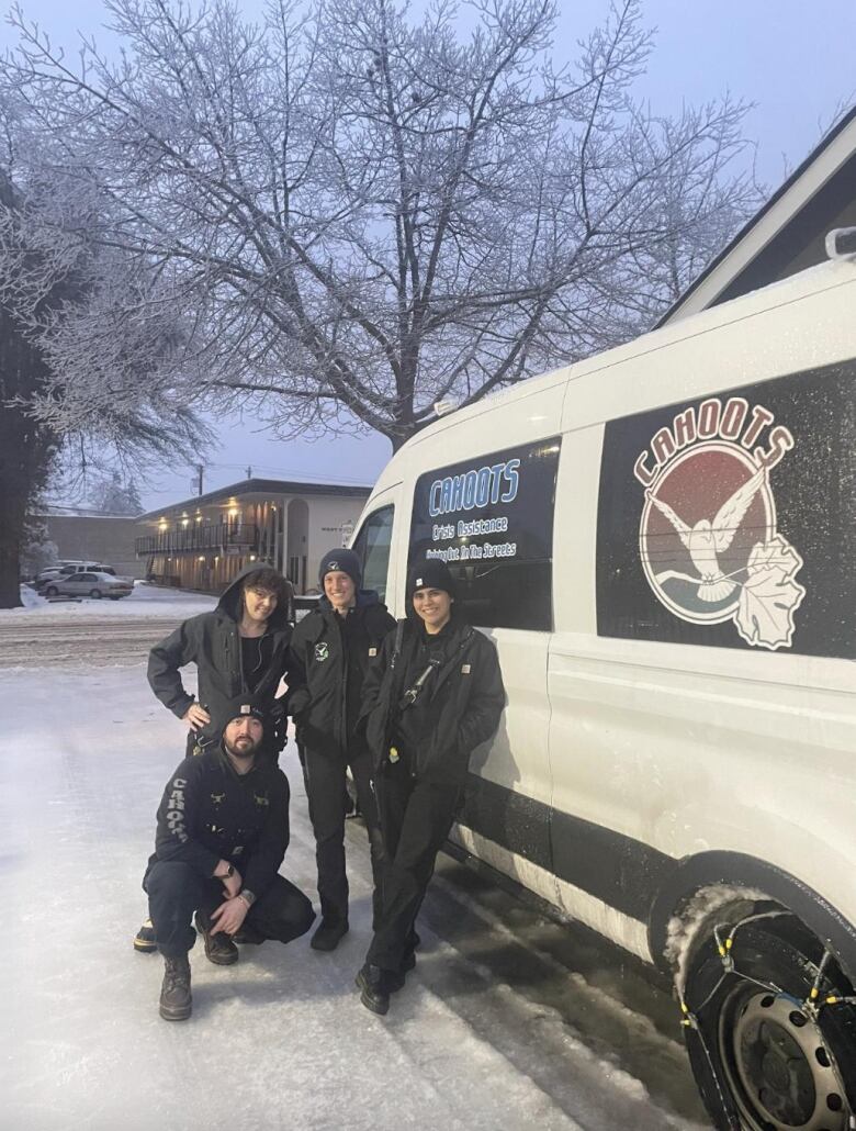 A group of people standing beside an outreach van