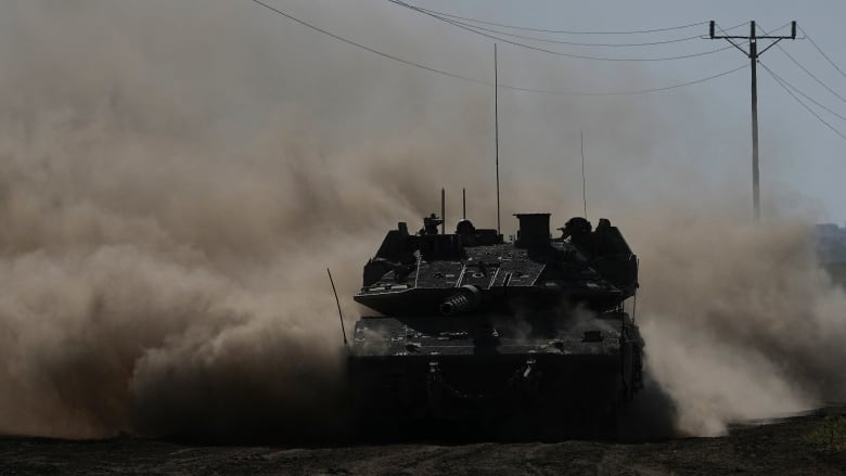 An Israeli tank moves near the border with the Gaza Strip in southern Israel.