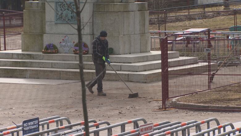 A municipal worker at Halifax Grand Parade sweeping up debris