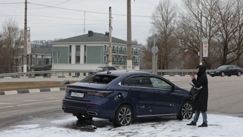 This picture shows a damaged car at the scene of fresh aerial attacks on Belgorod on March 14, 2024.