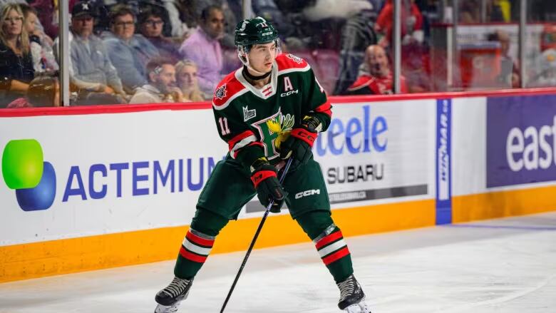 A hockey player skates down the ice