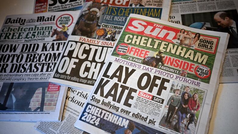 A collection of newspapers are placed on a table.