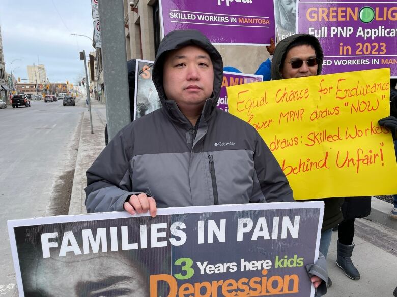 A man holds up a sign in protest.