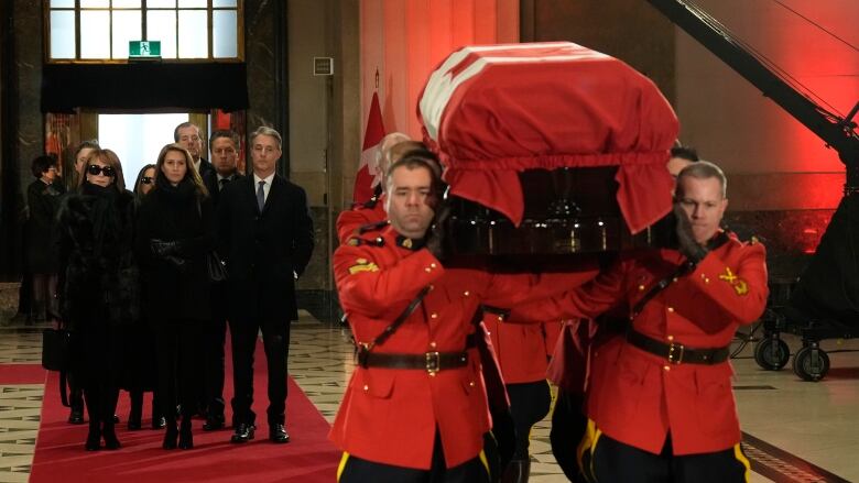 Members of the Mulroney family follow as an honour guard carries the casket of former prime minister Brian Mulroney into the Sir John A. Macdonald building opposite Parliament Hill in Ottawa on Tuesday, March 19, 2024.