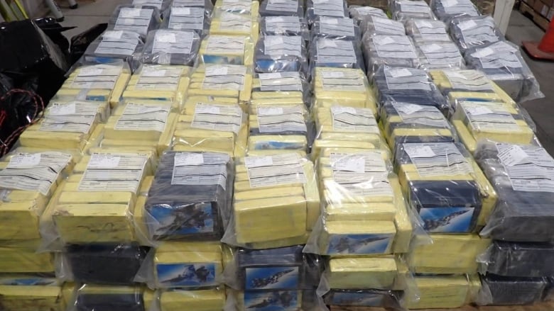 A stack of yellow and black cubes wrapped in plastic are shown.