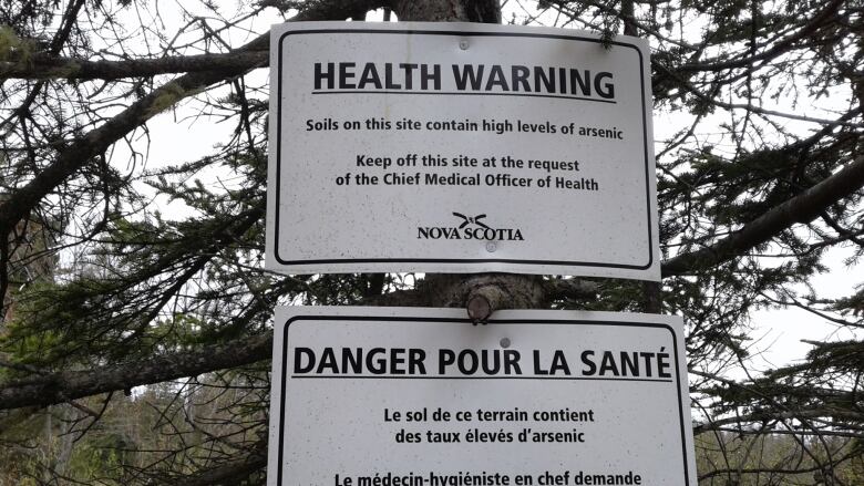 A sign posted in a former gold mining district in Dartmouth, N.S. warns of high levels of arsenic. 