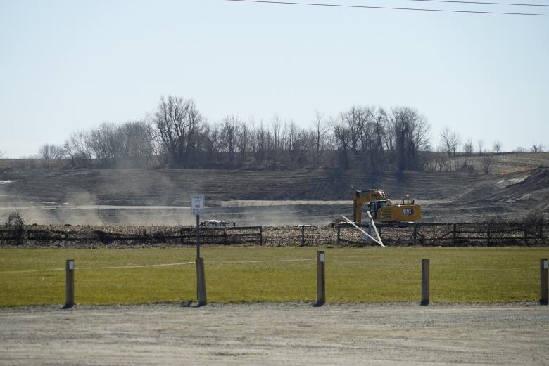 An excavator on farm land.