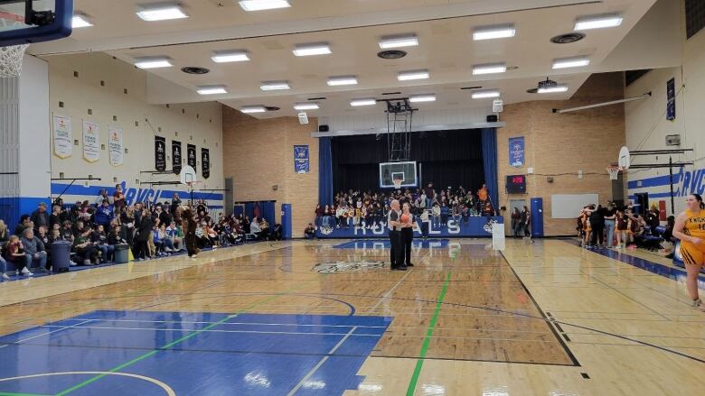 a gym is filled with people for a basketball tournament