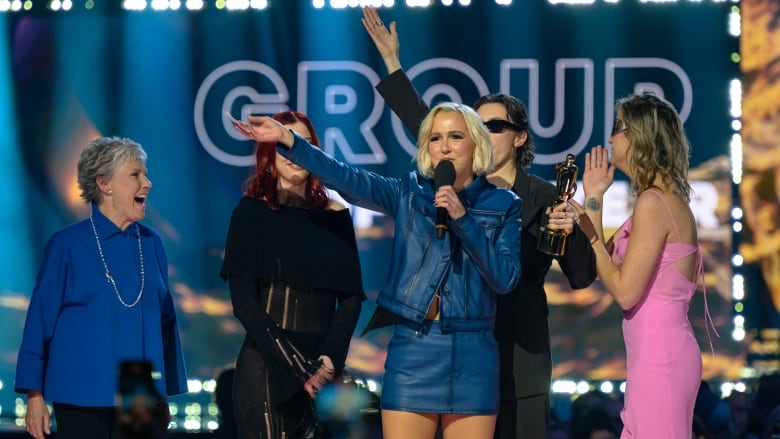 Rock band the Beaches accept their Juno Award for group of the year onstage in Halifax. Anne Murray, also in the picture, presented the trophy.