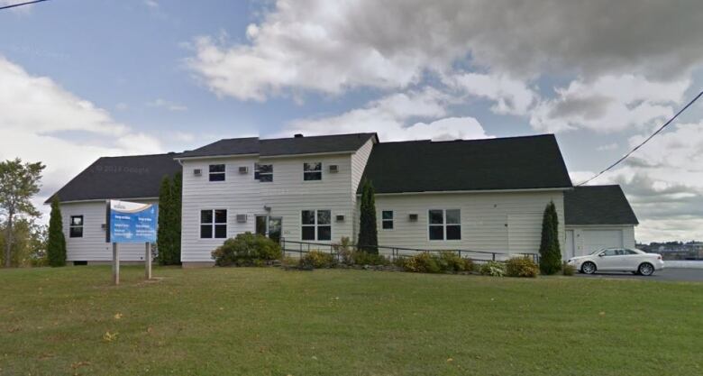 A white building with black roof.