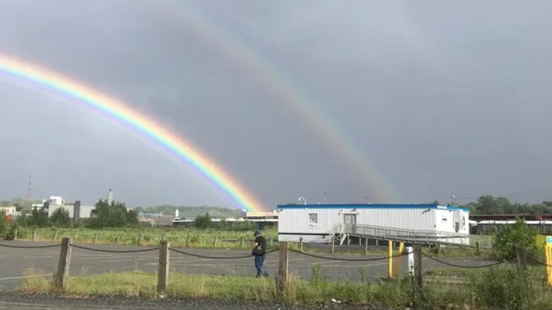 A building with a rainbow in the background.