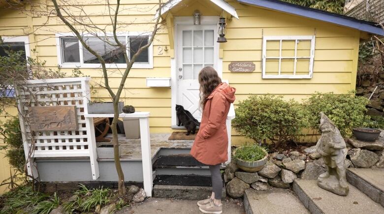 A woman walks her cat.