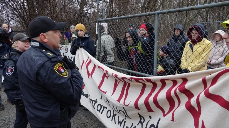 A group of people holding a banner that says 