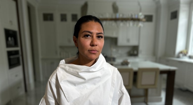 Woman standing in a kitchen.