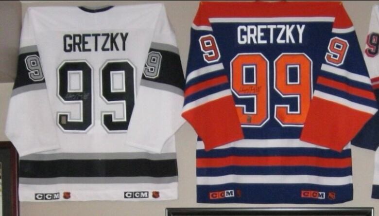 The backs of signed Wayne Gretzky Los Angeles Kings, Edmonton Oilers and New York Rangers hockey jerseys lined up side by side. 