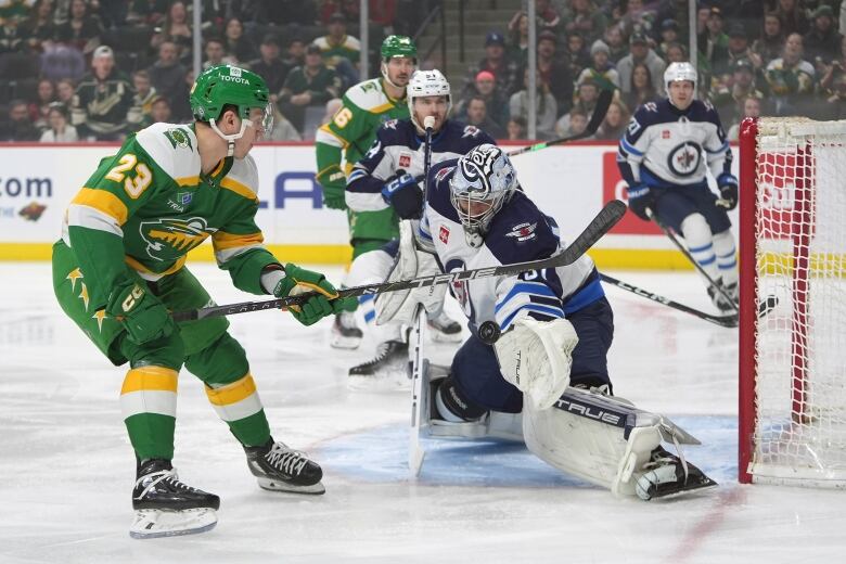 A hockey goalie stops a goal.