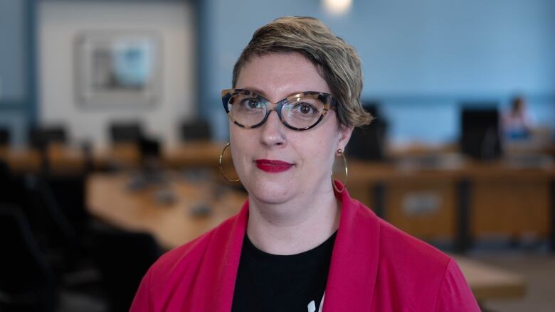 A city councillor poses in a meeting room.