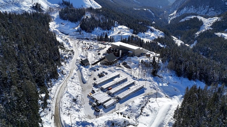 An aerial view photo of a processing plant at a mine. The ground is covered in snow.