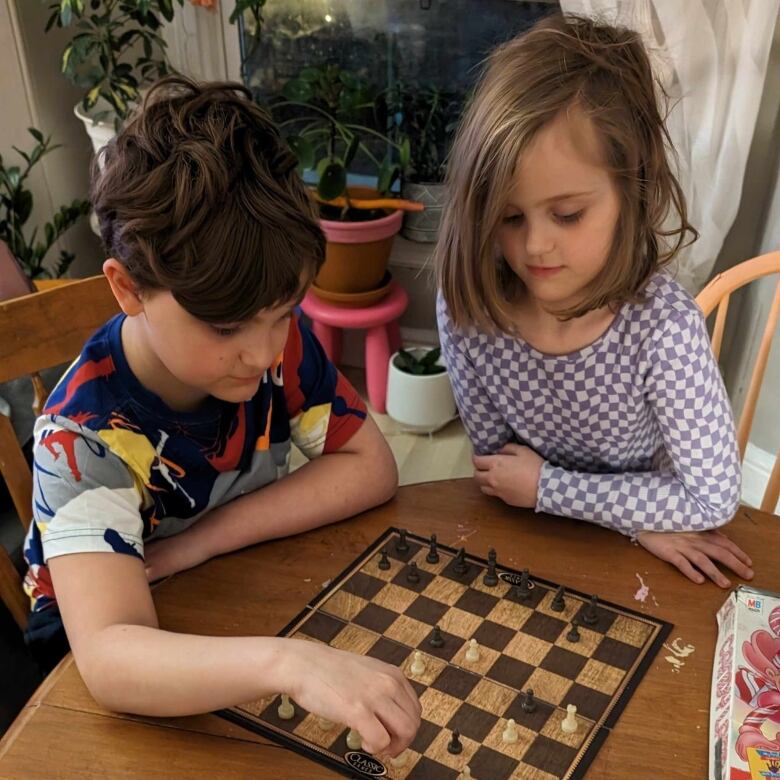 Two kids playing chess.