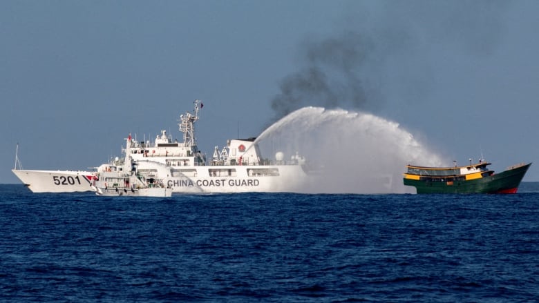 Chinese Coast Guard vessels firing water cannons at a Philippine resupply vessel last month in the South China Sea. 