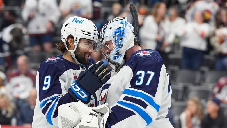 Two hockey players face each other.