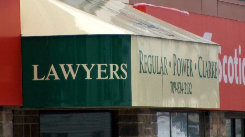 A green and white building sign. 