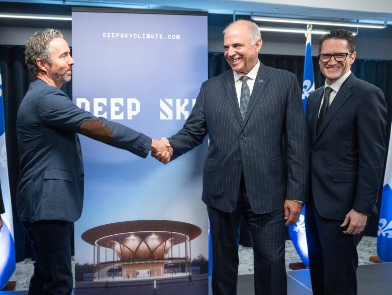 Deep Sky chief executive Fred Lalonde, left, shakes hands with Quebec Economic Development Minister Pierre Fitzgibbon as Environment Minister Benoit Charette, right, looks on after announcing initiatives to combat climate change  during a news conference Thursday, November 16, 2023 in Montreal.