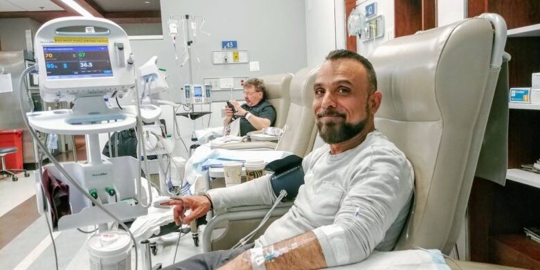 John Zeus Tokatlidis sits in a chair during a chemotherapy appointment