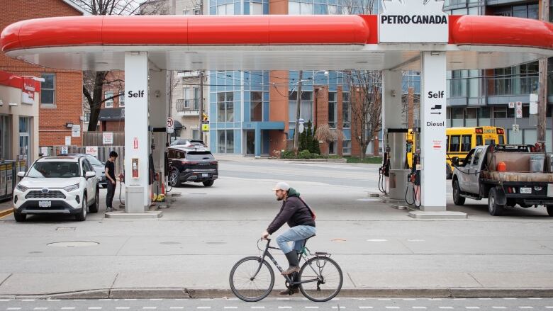 Toronto drivers gas up on April 18, 2024, after an overnight fuel price hike saw a litre of gasoline reach $1.80.