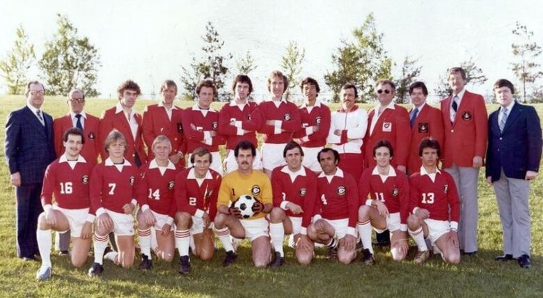 An old photo of a soccer team wearing red jerseys 