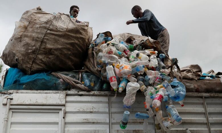 Workers in Nairobi offload plastic bottles for recycling.