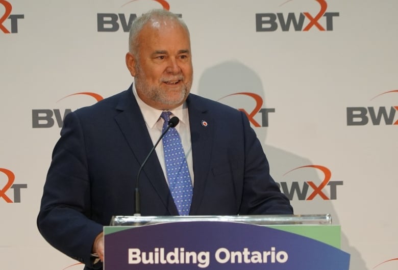 Portrait of Ontario Energy Minister Todd Smith on stage at a press conference.