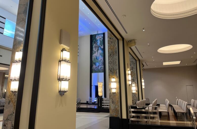 Art deco light fixture and marble coloumns highlight amid an art deco dining hall