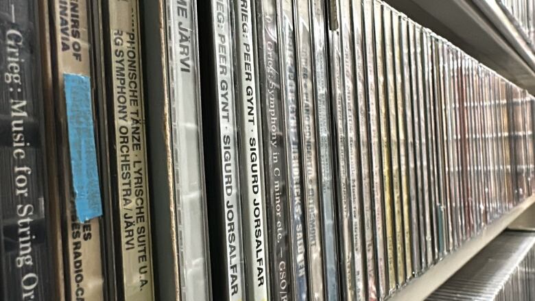 A shelf is stacked with records.