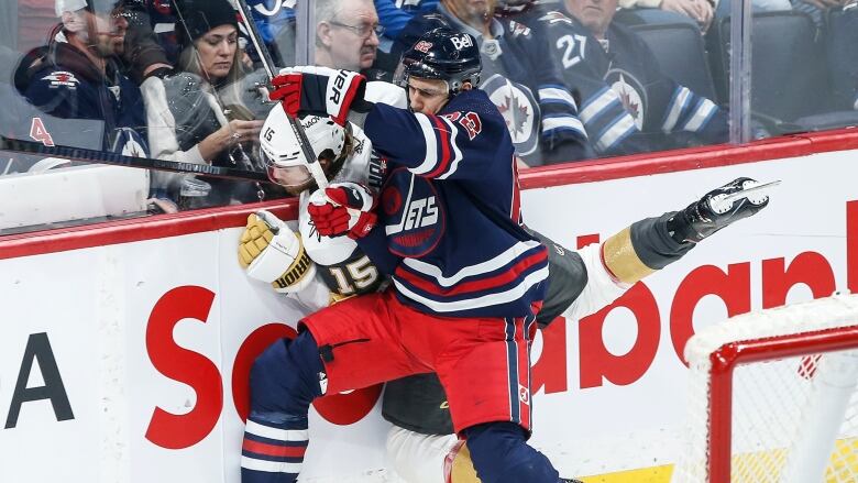 Two hockey players colliding.