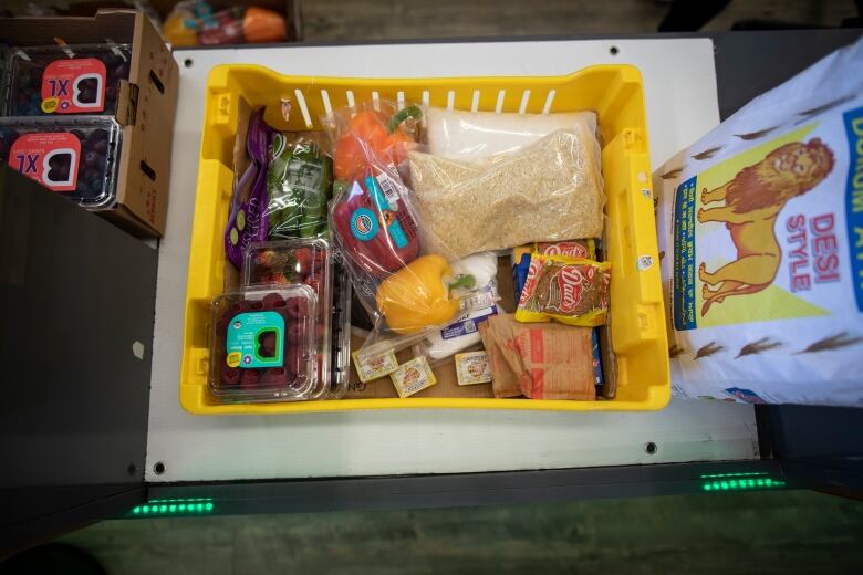 Volunteers pack groceries for people in need  at the Guru Nanak Food Bank in Delta, B.C on Friday April 19, 2024.  