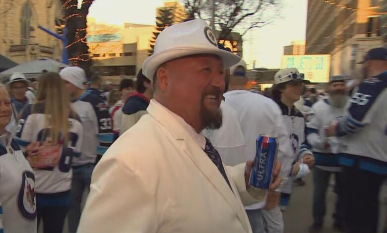 A man wearing a white suit