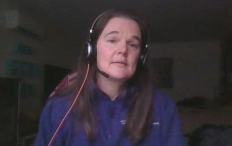 A woman wearing a headset.