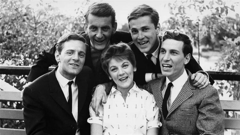 Four men and one woman pose for a group picture