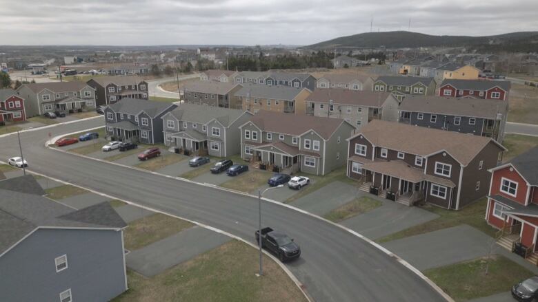 A view down from above of a street of four-plex homes.