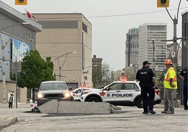 A large hole in a downtown roadway.